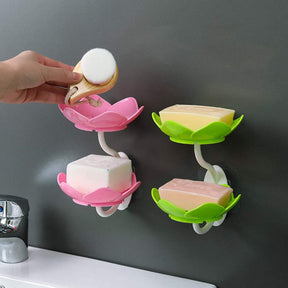 Flower-shaped self-draining soap dish holder for bathroom or kitchen use.