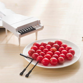 Cute piano-style fruit forks for fun snacking.